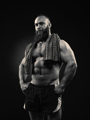 Fototapeta na wymiar Portrait of bearded strong man with perfect abs, pecs shoulders,