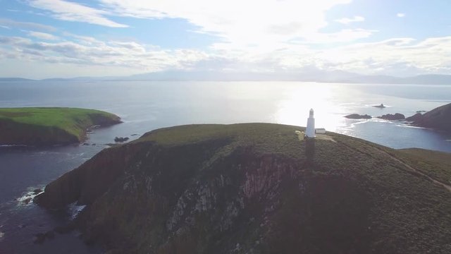 Orbit flight around Bruny Island Lighthouse revealing magnificent coastline, Tasmania, Australia