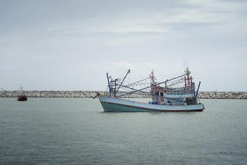 traditional fishing boat laying on the sea.cloudy sky.filtered image.selective focus