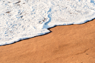 Foamy wave on the seashore.