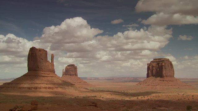 Wide shot of rock formations against cloudy sky at Monument Valley