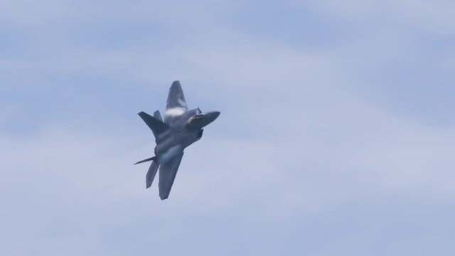 Slow motion tacking of fighter jet flying in the sky