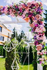 beautiful white arch with flowers for wedding ceremony