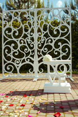 White table with lettering LOVE stands behind a wedding altar