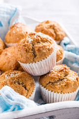 Delicious homemade coconut cinnamon muffins on old white tray. Healthy food concept.