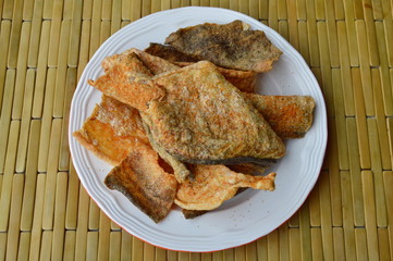 crispy fried fish skin with seasoning on dish