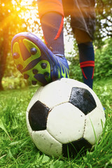 foot with footbal boots on the ball - obrazy, fototapety, plakaty