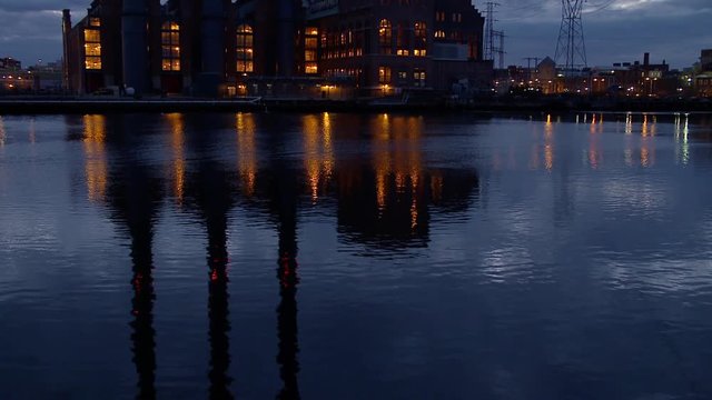 Tilt up shot of power plant during dusk