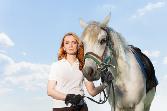Beautiful picture of young woman with white horse