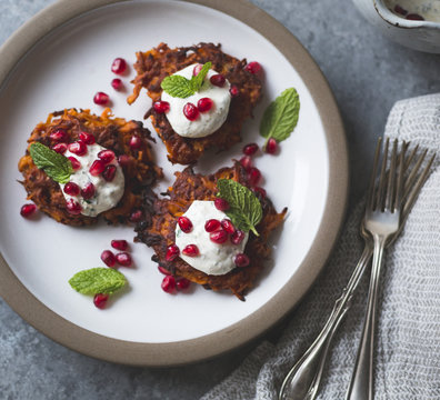 Harissa sweet potato latkes with spiced yogurt, mint and pomegra