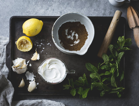 Ingredients for spiced garlic yogurt dip with mint.