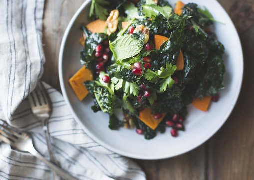 kale salad with herbs, pomegranate, persimmon