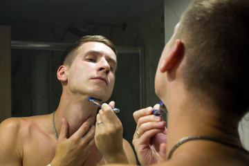 man shaving in the bathroom