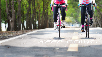Fototapeta na wymiar Bike lane and words of keep going on road, business concept and success idea