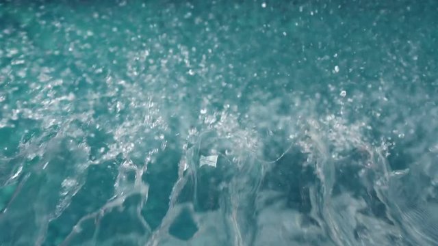 Video of streams of water pouring into the pool in slow motion
