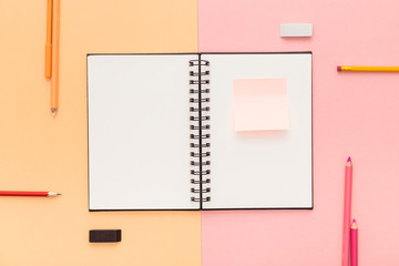 Open notebook with adhesive notes on the creative office desk. Student desk.