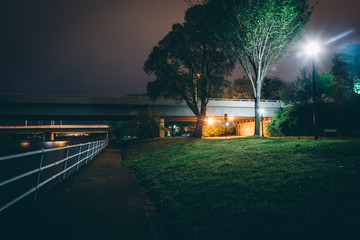 Path and bridges along the Potomac River at night, in Washington