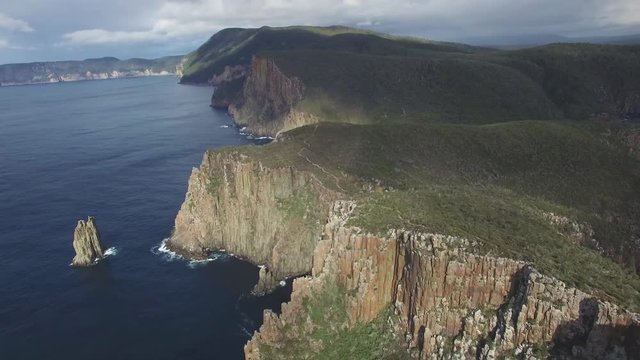 Flying towards and over rugged cliffs of Cape Hauy coastline in Tasman National Park, Tasmania, Australia