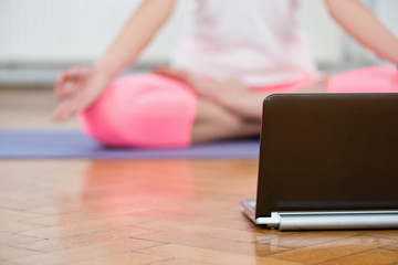 Yoga with notebook at home