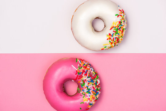 Donuts with icing on colorblock background. Sweet donuts.