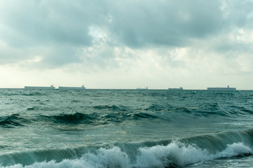 Oleaje con barcos cargueros al fondo