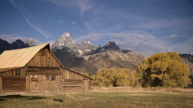 Wide shot of Mormon Row against Rocky Mountains
