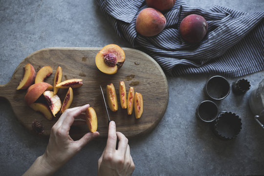 Woman slicing peaches