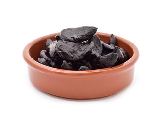 black garlics in an earthenware bowl