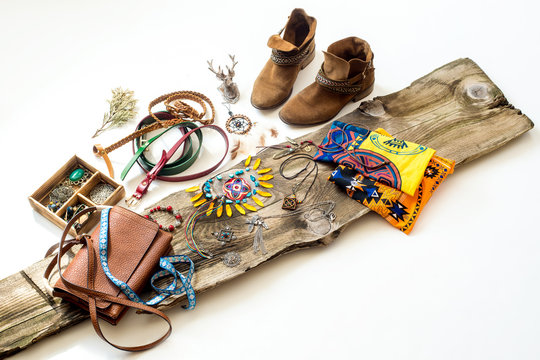 Boho decor and accessories: boots, bag, dream catcher,  feather, deer on the wood
