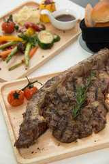  grilled  tomahawk beef steak cut  with fresh rosemary and tomat