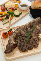  grilled  tomahawk beef steak cut  with fresh rosemary and tomat
