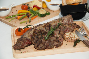  grilled  tomahawk beef steak cut  with fresh rosemary and tomat