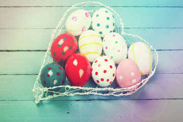 Easter concept with colored eggs on wooden background