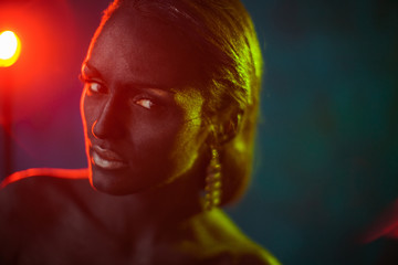 Red lamp shines behind bronze model