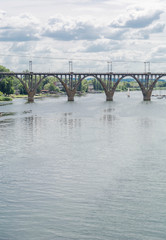 High arched railway bridge made of concrete across the Dnieper River in the city of Dnepropetrovsk. Ukraine, 9 July 2016