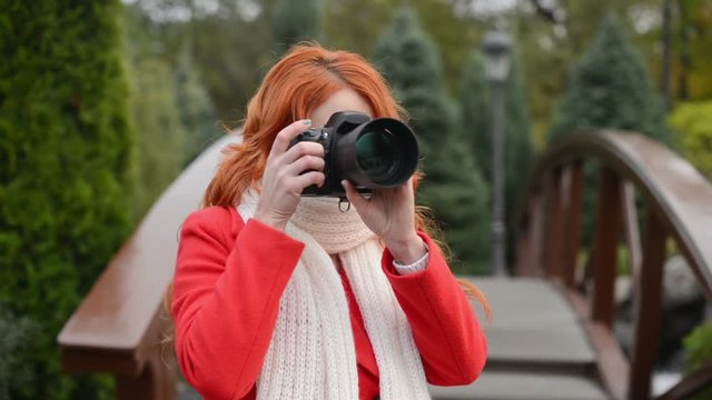 beautiful woman making photo using professional camera