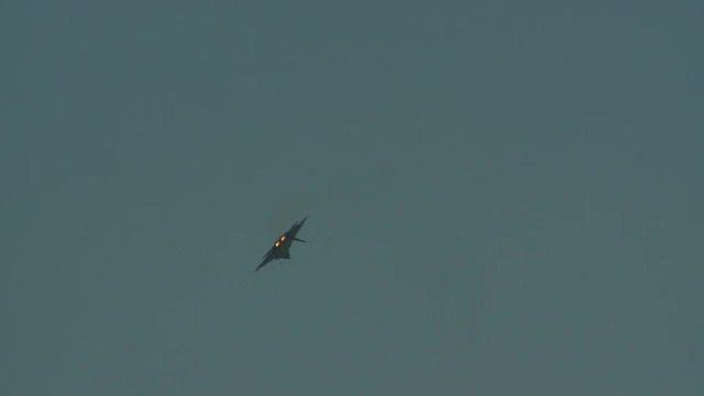 Tracking shot of F22 fighter jet flying in sky