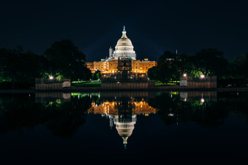 Fototapeta premium The United States Capitol Building and Reflecting Pool at night,