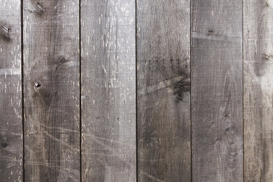 Old and weather worn brown wooden plank texture wall background 