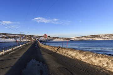 Road narrows over Nordlenangen fjord in Lenangsstraumen, Lyngen, Troms county, Norway