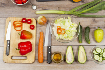 High Angle Still Life View of Knife and Wooden Cutting Board Surrounded by Fresh Herbs. Assortment...