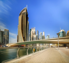 Obraz na płótnie Canvas Panoramic view of Dubai Marina bay with yacht and cloudy sky, Dubai, UAE