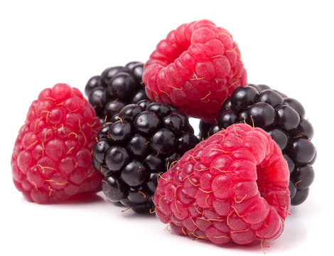 pile of raspberries and blackberries isolated on white background