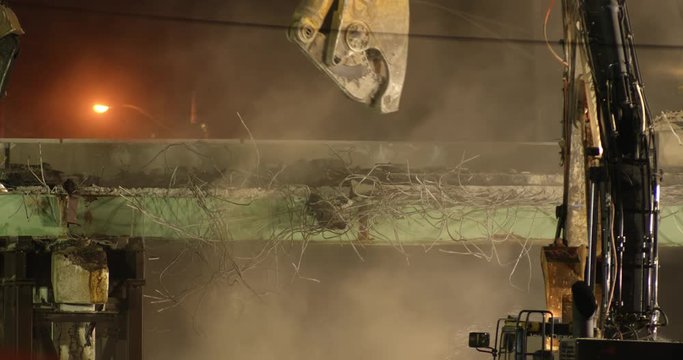 Close up of machine breaking bridge at night&nbsp;
