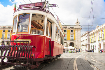 Fototapeta na wymiar Famous old red tram on street of Lisbon/Lisboa.Plaza de comercio