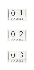 Closeup group of white wooden calendar with black 01 , 02 , 03 november  word , three date calendar isolated on white background