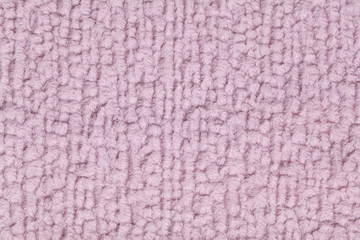 Light purple fluffy background of soft, fleecy cloth. Texture of textile closeup.