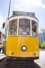Fototapeta na wymiar Famous old yellow tram on street of Lisbon/Lisboa.