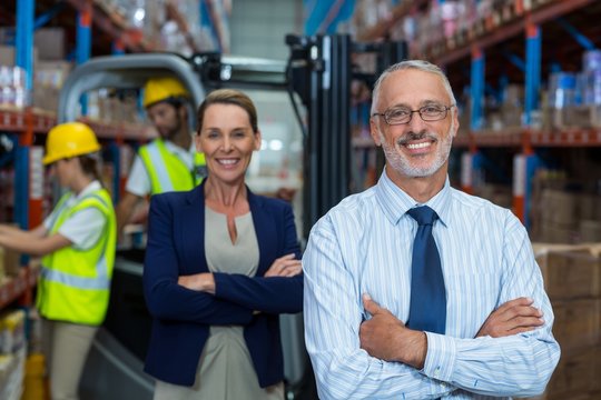 Portrait of warehouse manager and client smiling 