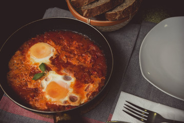 Breakfast shakshuka of fried eggs with tomato
